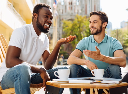 two men talking at a table